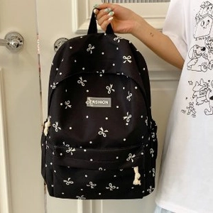 Lässiger schwarzer Canvas-Rucksack für Damen mit weißen Schleifen und Polka-Dot-Mustern
