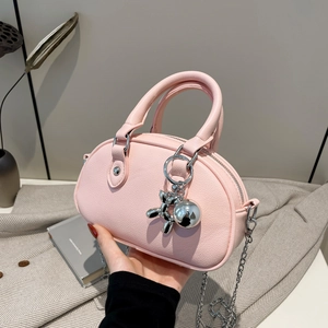 Pink lychee grain leather mini Boston bag with silver chain strap and balloon dog charm