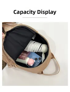 Internal capacity display of the quilted backpack showing phone, umbrella, and makeup