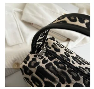 Close-up of leopard print bag featuring jacquard fabric and smooth silver metal zipper