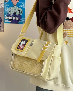 Side view of yellow nylon messenger bag with transparent PVC pocket and white rings
