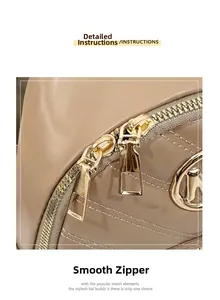 Detailed close-up of smooth dual golden zippers and quilted faux leather on beige backpack