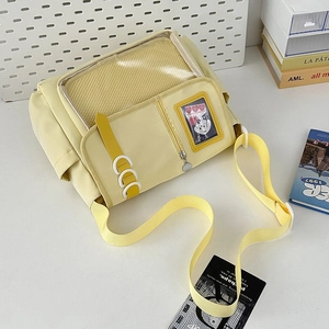 Detail of yellow nylon ita bag with large transparent mesh window and adjustable strap