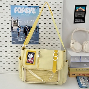 Macro shot of pale yellow ita bag showing durable nylon texture and clear display pocket