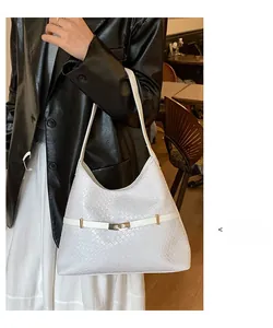 Detailed view of white woven texture shoulder bag with elegant gold metal lock buckle