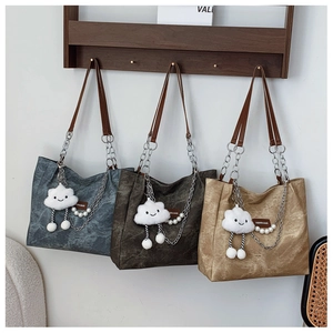 Three textured faux leather tote bags in gray, dark brown and tan with pearl accessories
