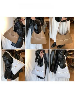 Detail view of khaki and white snakeskin pattern tote bags with metal buckles on models