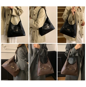 Detail view of woven leather tote bag with classic turn-lock closure in black and brown