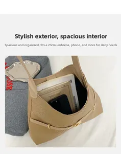 Spacious interior of beige woven shoulder bag holding a 23cm umbrella and smartphone