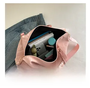 Macro view of a large pink travel bag interior showing spacious storage for essentials
