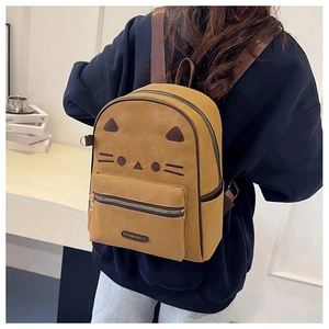 Detail view of cartoon cat backpack with 3D ears and embroidery on khaki canvas