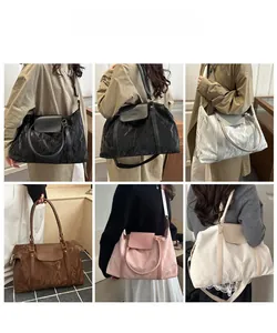 Detail view of large tote bags in five colors with unique pleated texture and leather flaps