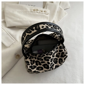 Top view of mini leopard print handbag showing interior storage for phone and wallet