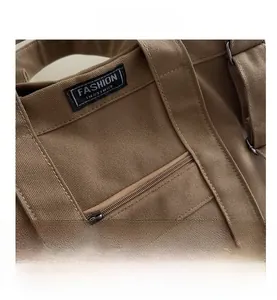 Macro detail of khaki canvas tote bag showing fashion instinct label and precise stitching