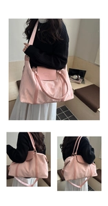 Detail view of pink textured tote bag with leather flap and adjustable shoulder strap