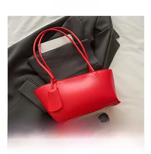 Detailed comparison of the large red tote bag size with a smartphone for scale reference