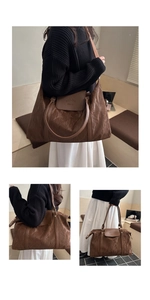 Detailed view of brown tote bag with embossed texture and elegant logo engraving