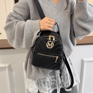 Chic black mini quilted backpack for women featuring a gold M logo and versatile straps