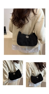 Detail showing black suede crescent bag with gold double-ring buckle and chain strap