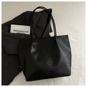 Detailed close-up showing black woven texture and material of the large capacity tote bag