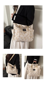 Detail view of beige canvas tote bag featuring floral patterns and multiple storage pockets