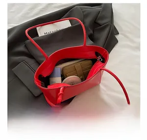 Internal view of red leather tote bag showing large capacity and inner zipper pocket