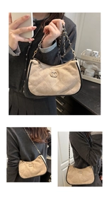 Close-up of beige quilted suede shoulder bag featuring gold chain and double ring hardware