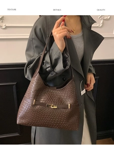 Close-up of deep brown woven texture shoulder bag with gold metal buckle detail