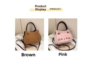 Detail view of cartoon cat-shaped shoulder bags in brown and pink matte synthetic leather