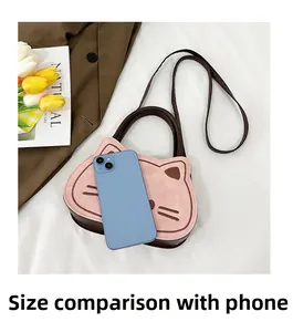 Pink cartoon cat crossbody bag size comparison with a smartphone on white background