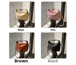 Close-up of pleated women handbag in beige, pink, brown, and black colors