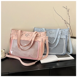 Detail view of pink and blue ita bags with heart lock and large clear display windows