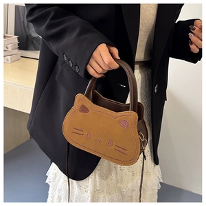 Detailed view of camel cartoon cat crossbody bag with fine embroidery and suede texture
