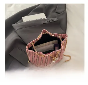 Top view of pink tweed bucket bag showing spacious interior with metal chain strap