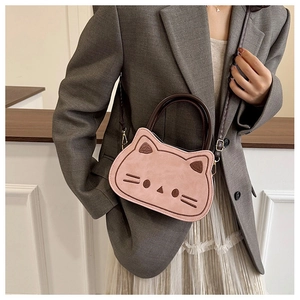 Detail of pink cat-shaped toddler handbag with embroidered face and brown shoulder strap