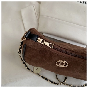 Brown suede underarm bag with gold chain strap and metal buckle in retro style