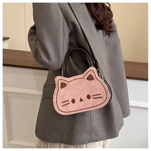 Detailed pink cartoon cat crossbody bag with embroidery and dual handle shown on model