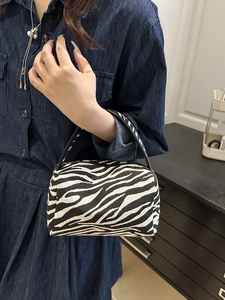 Mini zebra print cylinder handbag with black handles for a stylish everyday casual look