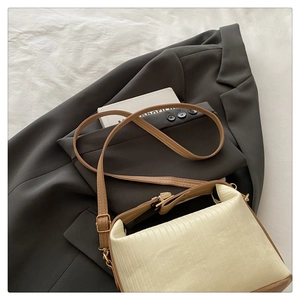 Detailed macro view of beige vertical textured leather and golden strap buckle
