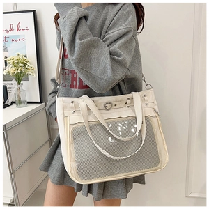 Detail of cream white ita bag with heart buckle and transparent display window