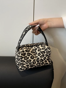 Mini leopard print fabric tote bag with black faux leather handles and zipper closure