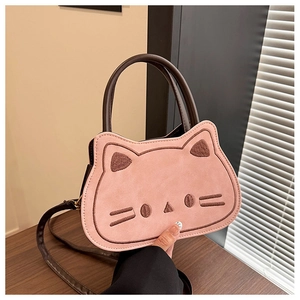 Close-up of pink cat-shaped handbag with embroidered whiskers and brown handle