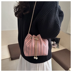 Pink and black herringbone woven bucket bag with pearl drawstring and gold chain