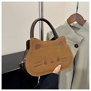 Detail of cute cat shaped handbag with high-quality embroidery and brown faux leather
