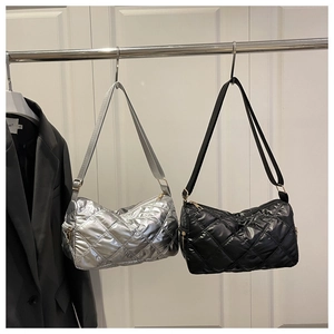 Detailed view of silver and black quilted rhomboid shoulder bags with metallic finish