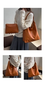 Brown leather tote bag detail with gold logo and matching inner pouch on a model
