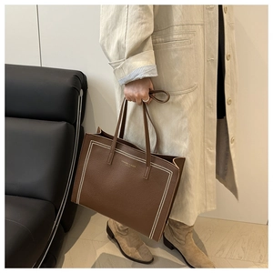 Brown lychee grain leather tote bag with white decorative stitching and golden logo