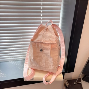 Pink lightweight nylon backpack for women with drawstring closure and metal logo detail