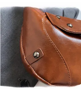 Detail of vintage brown PU leather texture with dark stitching and gunmetal rivets