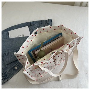 Detail view of heart pattern corduroy tote bag showing interior space and magnetic closure